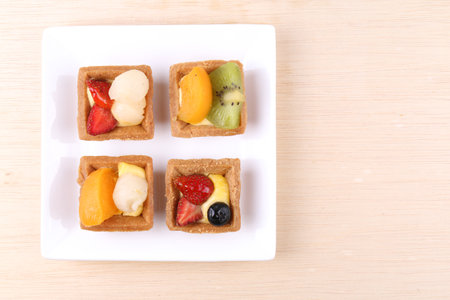 Assorted fruit tarts on a plateの写真素材