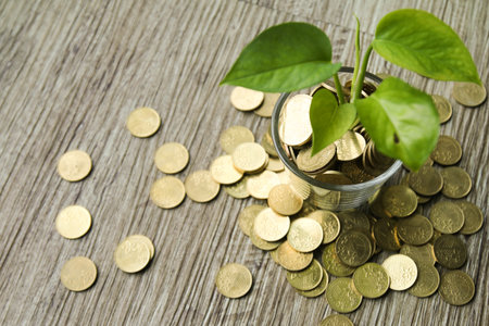 Business concept of financial growth with plant growing out of glass of money