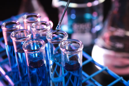 Reagent dropped into test tube containing blue chemicals