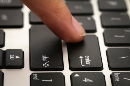 Finger pressing on ENTER button