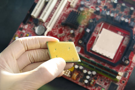 Gloved hand holding microprocessor chipの写真素材