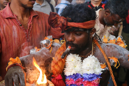 Hindu devotee preparing for ritual during Thaipusam at Batu Caves, Kuala Lumpur, Malaysiaのeditorial素材