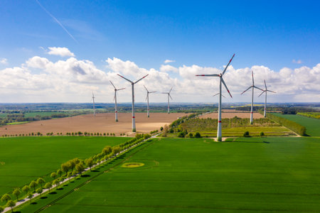 aerial view of agricultural fields with windmills or turbines