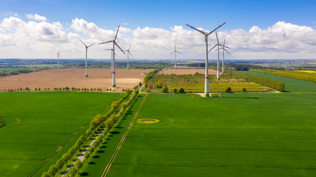 aerial view of agricultural fields with windmills or turbines