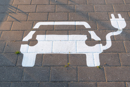 white car sign for parking and charging of cars painted on the streetの写真素材