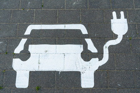 white car sign for parking and charging of cars painted on the streetの写真素材