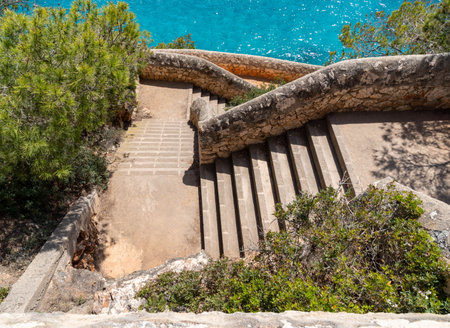 old stone wall and stairs at the mediterranean seaの写真素材