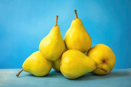 Fresh yellow pears on blue background. Healthy food concept. Copy space.の素材