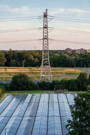 Solar panels and high-voltage power lines on the background of the city