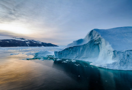 Antarctic landscape with icebergs and ice floes at sunset