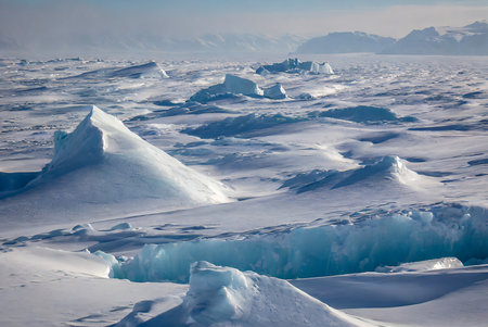 Antarctic landscape with icebergs and icebergs in the foreground