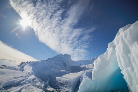 icecaps in the Antarctica with iceberg in the ocean swimming around and melting in the seaの写真素材