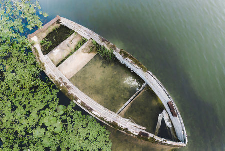 Abandoned boat on the lake, top view of old boatの写真素材