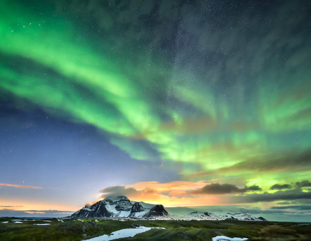 Aurora borealis in the sky over the mountains in Icelandの写真素材