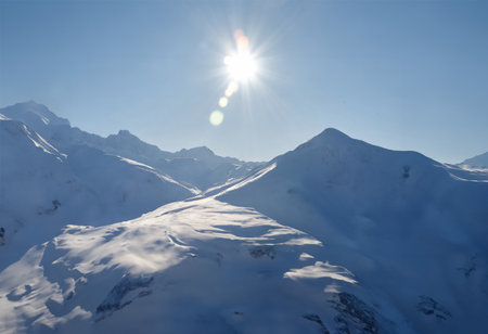 Beautiful winter mountains landscape with snow covered peaks and clear blue skyの写真素材