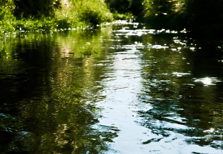 Reflection of the sun in the river water. Natural background.