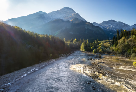 Mountain landscape with river and forest at sunrise. Caucasus, Russiaの写真素材