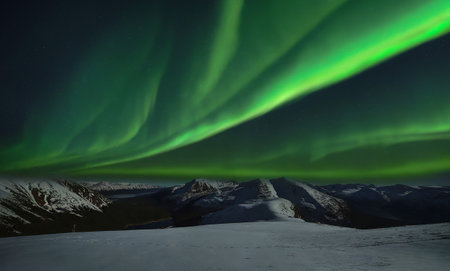 Aurora borealis, northern lights over the mountains in winterの写真素材