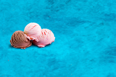 Scoops of ice cream on a blue background with copy spaceの写真素材