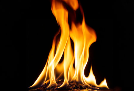 Fire flames on black background. Closeup of fire flames isolated on black background.