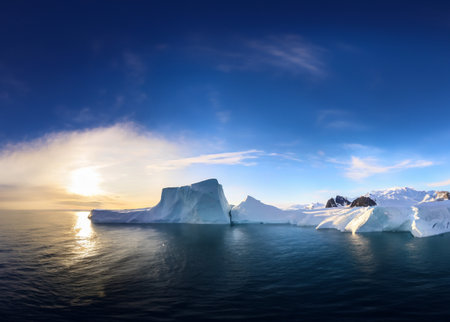 Antarctic landscape with icebergs in the ocean at sunset.の写真素材