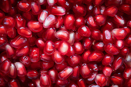 Pomegranate peeled seeds background. Top view.
