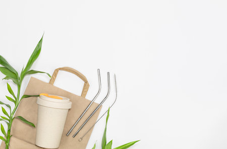 Reusable bamboo cup, glass bottle, stainless steel straws and paper.の写真素材