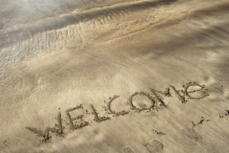 word welcome written on the sea beachの写真素材
