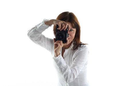 young woman with old camera isolated on white backgroundの写真素材