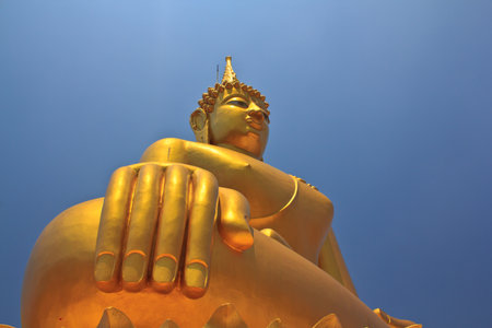 Big Buddha image on blue sky background in Thailandの写真素材