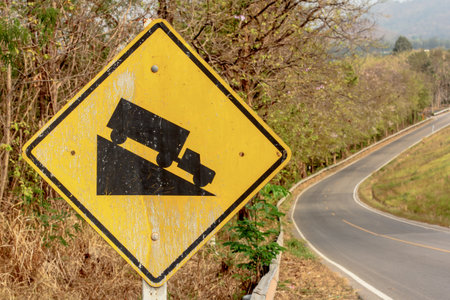 Steep grade hill ahead warning road signの写真素材
