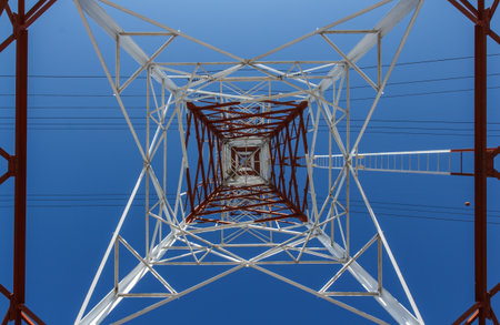 Power transmission lines against blue skyの写真素材