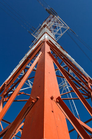 Power transmission lines against blue sky