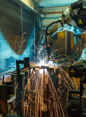 Welding Robot movement in a car factoryの写真素材