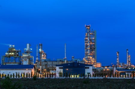 Oil refinery plant at twilight dark blue sky