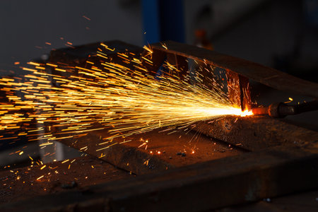 Sparks while cutting steel in the factory.