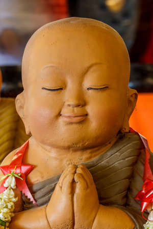 Statues of monks small yellow glaze.の写真素材