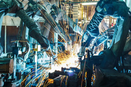 Team welding robots represent the movement in the automotive parts industryの写真素材