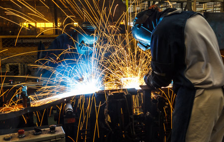 Team worker with protective mask welding.の写真素材