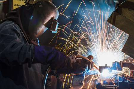 worker with protective mask welding metalの写真素材