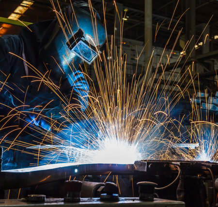 worker with protective mask welding metalの写真素材