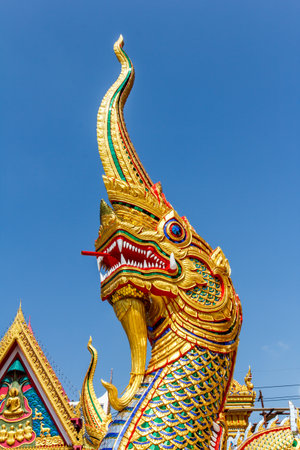 naga statue in thai temple on blue sky backgroundの写真素材