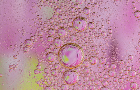 Oil drops on a water surface purple abstraction with bubbles