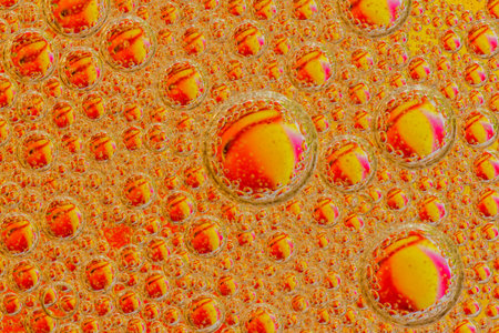 Oil drops on a water surface purple abstraction with bubblesの写真素材