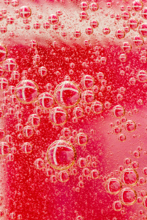 Oil drops on a water surface purple abstraction with bubblesの写真素材