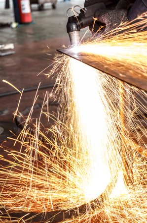 manufacturing metal construction by cutting to shape using huge orange sparks