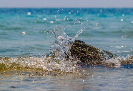 Stormy waves hitting rock on a tropical beachの写真素材