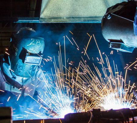 The movement of workers with protective mask welding metal.