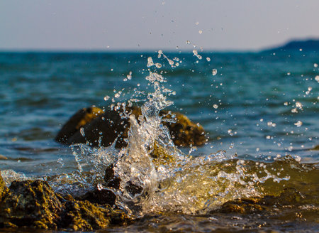 Stormy waves hitting rock on a tropical beach