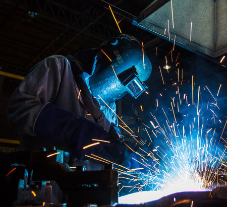 The movement of workers with protective mask welding metal.